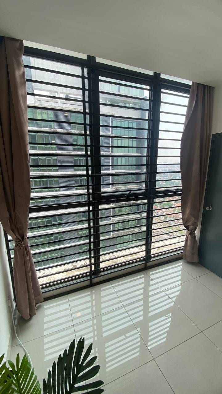 A mild steel window grille with vertical bars, seen from inside a room.